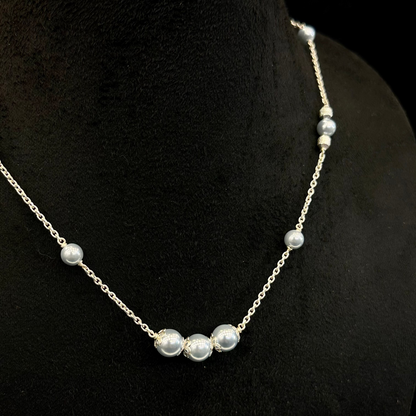 Pearl necklace on a black mannequin