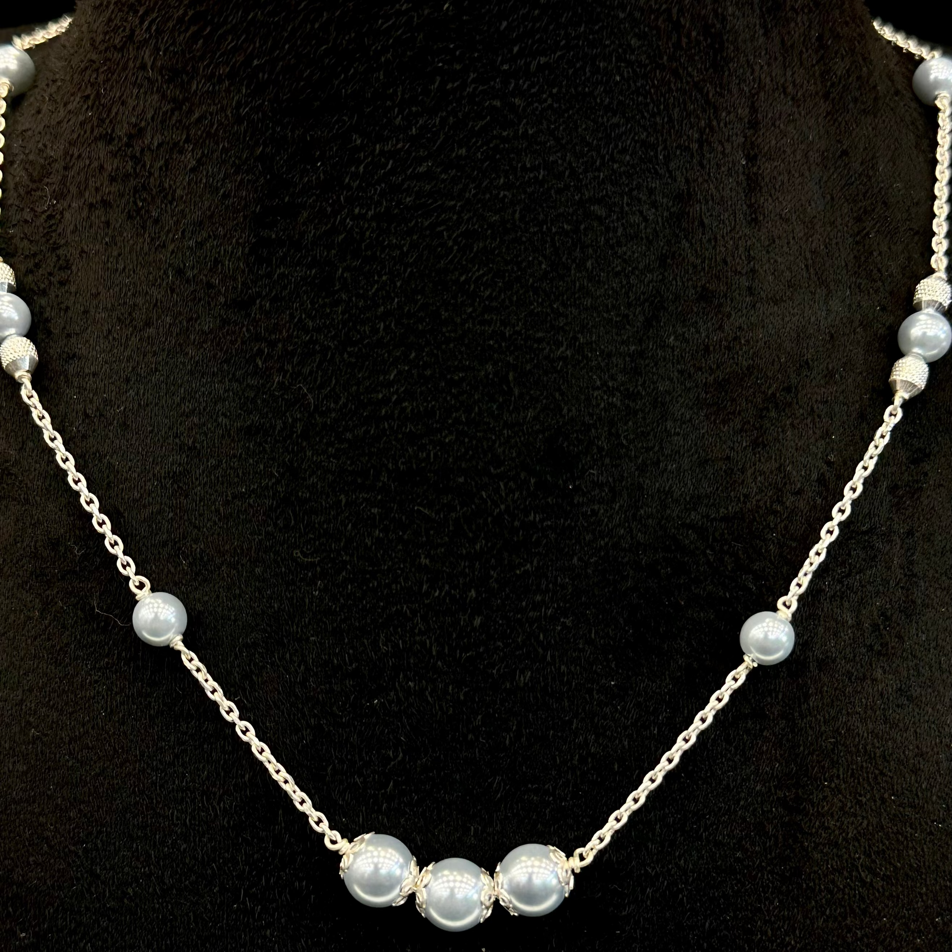 Pearl necklace on a black stand