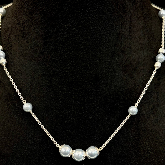 Pearl necklace on a black stand