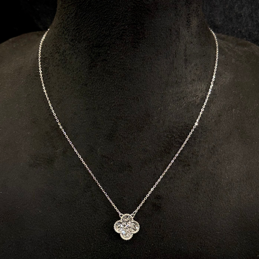 Silver necklace with a pendant on a black mannequin bust.