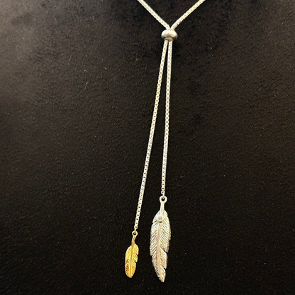Necklace with feather pendants on a black background
