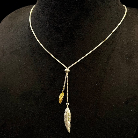 Necklace with feather pendants on a black mannequin bust