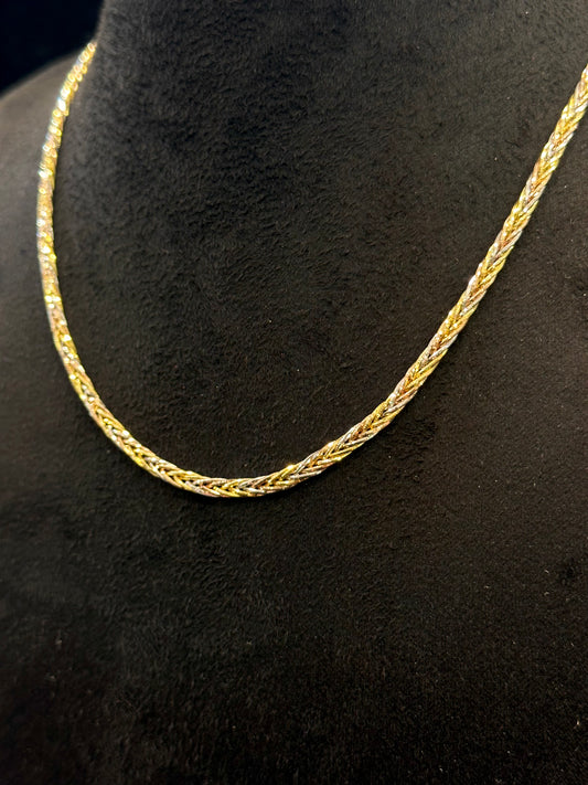 Gold chain necklace on a black background