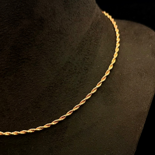 Gold rope chain necklace on a black mannequin bust