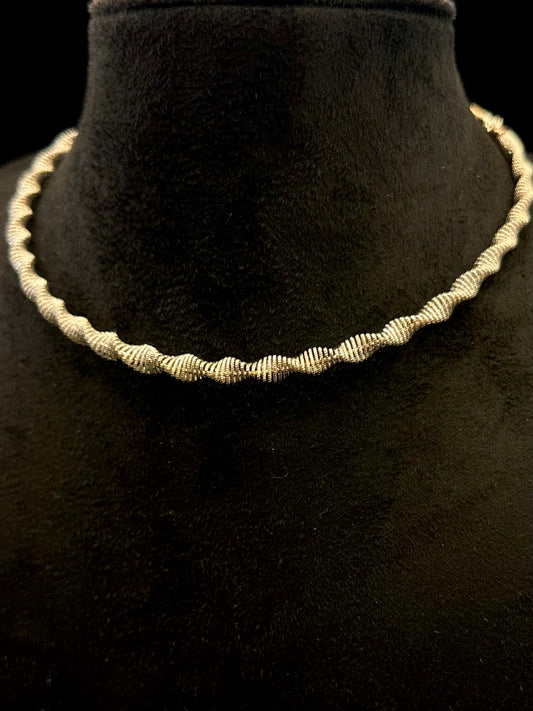 Silver necklace on a black mannequin bust