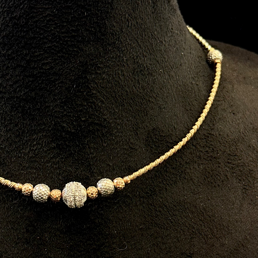 Necklace with textured beads on a black mannequin