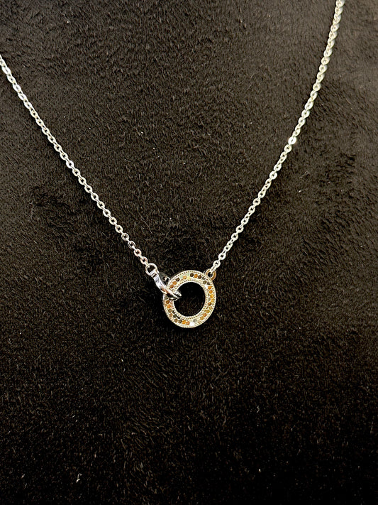 Necklace with a circular pendant on a dark textured background