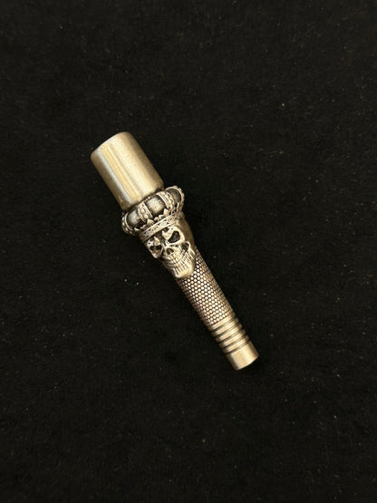 Decorative metallic object with intricate design on a black background