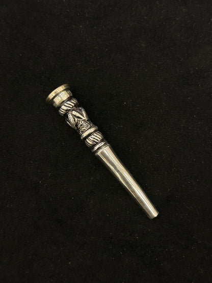 Silver decorative object on a black background