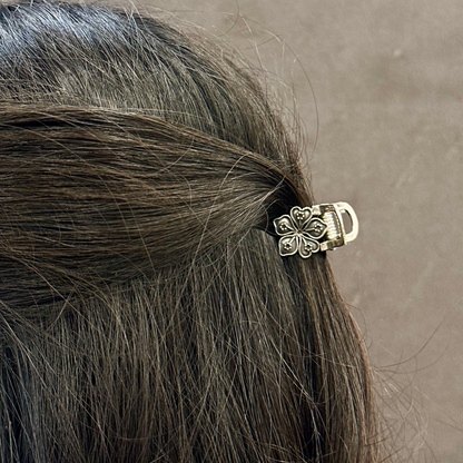 Close-up of a hair clip in a person's hair with a neutral background