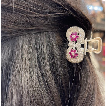 Close-up of a decorative hair clip in gray hair with blurred background